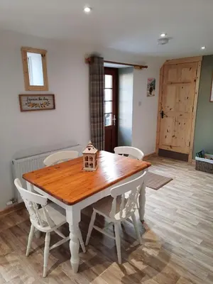 a dining room table with chairs and a bird house on it at A Stylish Country Retreat! in Keilour