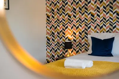 a bedroom with a bed with a colorful headboard at Glenfiddich Apartment in Oban
