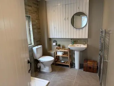 a bathroom with a toilet and a sink at Eldon Cottage in Isle of Arran