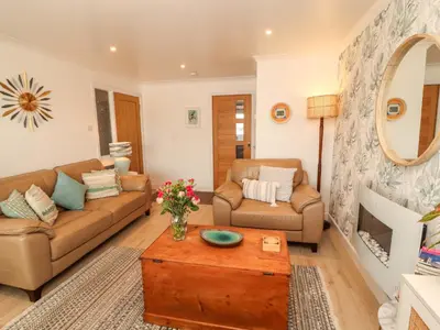 a living room with two couches and a table at The Paddock in Kirkcowan