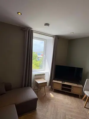 a living room with a flat screen tv and a window at Central Oban 2BR Short walk to Ferries and Harbour in Oban