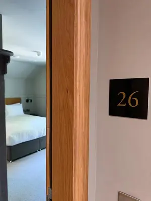 a room with a bed and a sign on a door at Oban House House in Oban