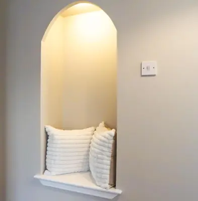 a mirror on a shelf with two pillows at Cottage in Crieff in Crieff