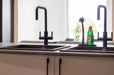 a kitchen counter with two sinks and a bottle of soda at Alexandra Apartment - Single Room #1 in Falkirk