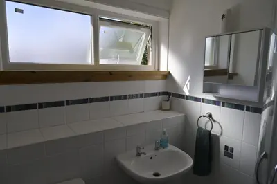 a bathroom with a sink and a window at Stylish Coastal Retreat in Saltcoats in Stevenston