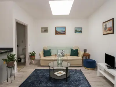 a living room with a couch and a table at Bathach Mor in Oban