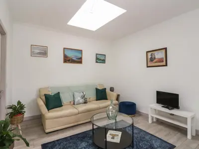 a living room with a couch and a tv at Bathach Mor in Oban