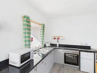 a kitchen with a microwave and a sink at Bathach Beag in Oban