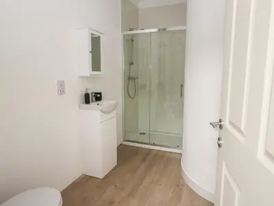 a bathroom with a shower and a toilet and a sink at Bathach Beag in Oban