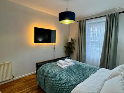 a bedroom with a bed with towels on it at Stylish 2BR Grassmarket Flat with Castle Views & PS5 in Edinburgh