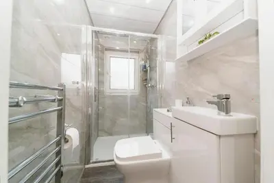 a bathroom with a toilet and a shower and a sink at Luxury House in Glasgow in Mansewood