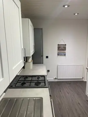 a kitchen with a stove and a refrigerator at Luxury House in Glasgow in Mansewood
