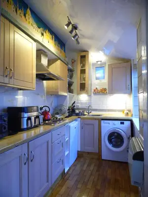 a kitchen with white cabinets and a washing machine at 2 Bedroom & 2Bathrooms in Lancaster in Moffat