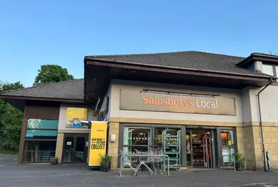 a store with a table in front of it at Coastal Village Property in Inverkip