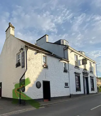 a white building on the side of a street at Coastal Village Property in Inverkip