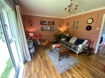 a living room with a couch and a table at Coastal Village Property in Inverkip