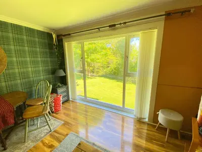 a living room with a large sliding glass door at Coastal Village Property in Inverkip