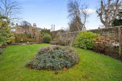 a garden with a bush in the middle of a yard at Merchiston 1 Room in Shared Apartment with Parking - Edinburgh in Edinburgh