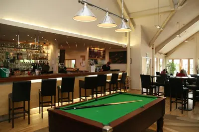 a pool table in a room with a bar at 6, The Gallops, Mains of Taymouth Estate, Kenmore in Kenmore