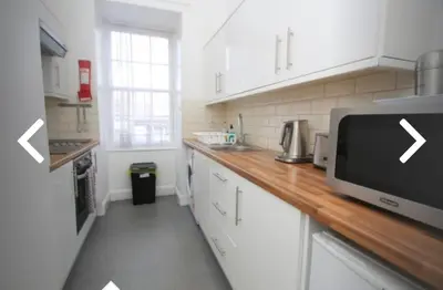 a kitchen with a counter top with a microwave at 52, Charlotte Street Apartments in Glasgow