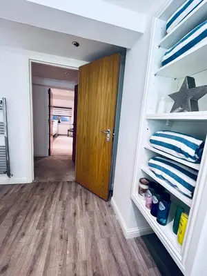 a room with a door and a closet at Unique Modern Studio Apartment in Motherwell