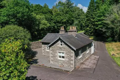 an aerial view of a stone house with a driveway at Mid Lodge, Penninghame Estate in Challoch