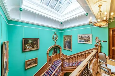 a staircase in a room with green walls and a ceiling at Penninghame Estate - Tower Apartment in Challoch