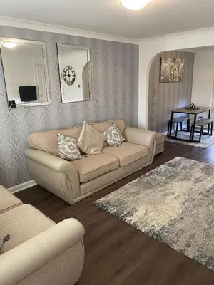 a living room with a couch and a table at Millview house in Airdrie