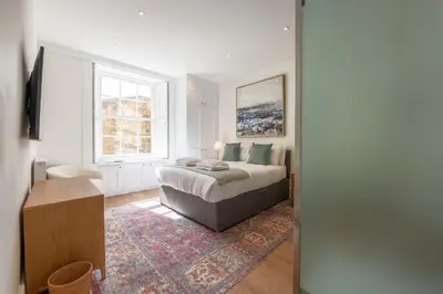 a bedroom with a bed and a window at Wemyss Hideaway Retreat in Edinburgh