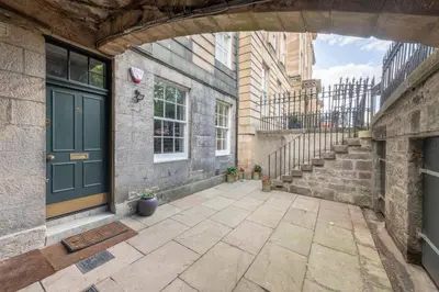 an entrance to a building with a green door at Wemyss Hideaway Retreat in Edinburgh
