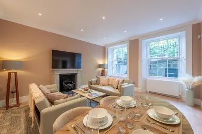 a living room with a couch and a table at Wemyss Hideaway Retreat in Edinburgh