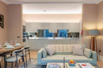 a living room with a couch and a table and a kitchen at Wemyss Hideaway Retreat in Edinburgh