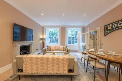 a living room with a couch and a table and chairs at Wemyss Hideaway Retreat in Edinburgh