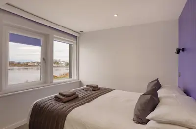 a bedroom with a bed with two towels on it at Oyster Inn Connel in Oban