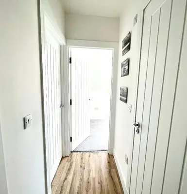 an empty hallway with a door leading into a room at Cuan Flat - Oban in Oban