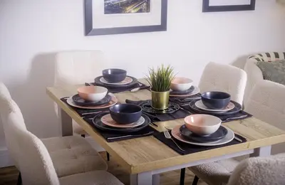 a wooden table with cups and saucers on it at Cuan Flat - Oban in Oban