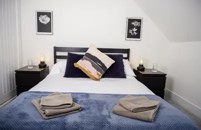 a bedroom with a bed with towels on it at Cuan Flat - Oban in Oban