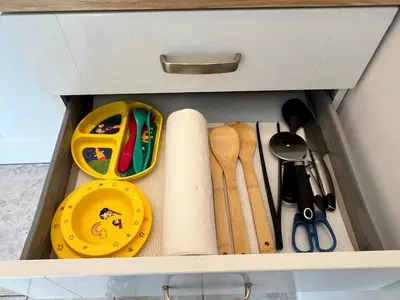 a drawer full of kitchen utensils in a cabinet at Self-contained ground level cottage with hill view in Edinburgh