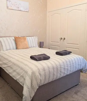 a bedroom with a bed with two pillows on it at Kirk street apartment in Campbeltown