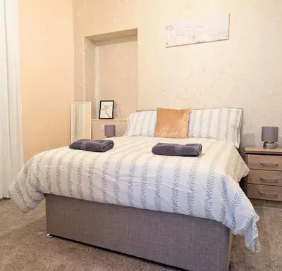 a bedroom with a bed with two pillows on it at Kirk street apartment in Campbeltown