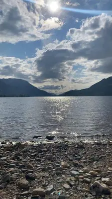 a view of a large body of water with mountains at Lochside Cottage Glencoe