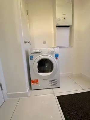 a washer and dryer in a small room at Entire Spacious 3-Bed Family Home, City Centre, Free Parking, Garden in Glasgow