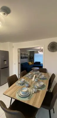 a dining room table with plates and dishes on it at Entire Spacious 3-Bed Family Home, City Centre, Free Parking, Garden in Glasgow