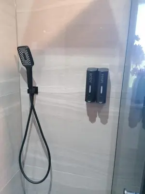a glass door with a blow dryer in a room at Entire Spacious 3-Bed Family Home, City Centre, Free Parking, Garden in Glasgow