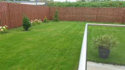 a yard with a fence and a tennis court at Entire Spacious 3-Bed Family Home, City Centre, Free Parking, Garden in Glasgow
