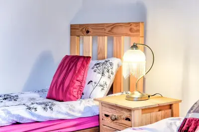 a bedroom with a bed and a lamp on a table at Edinburgh Central Morrison Apartment in Edinburgh