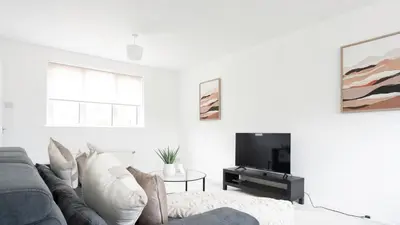 a living room with a couch and a tv at Craigseaton House in Broxburn
