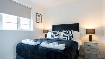 a bedroom with a bed with two towels on it at Craigseaton House in Broxburn