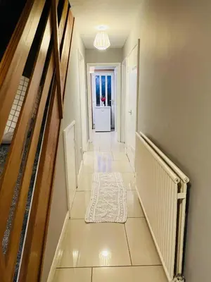a hallway with a staircase with a rug on the floor at Bank West in Edinburgh