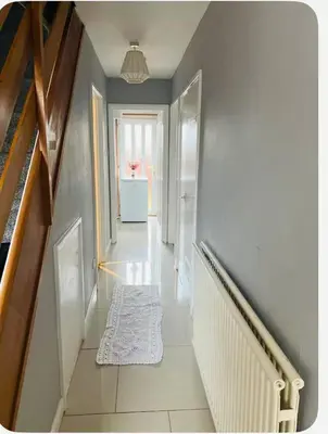 a hallway with a staircase with a rug on the floor at Bank West in Edinburgh